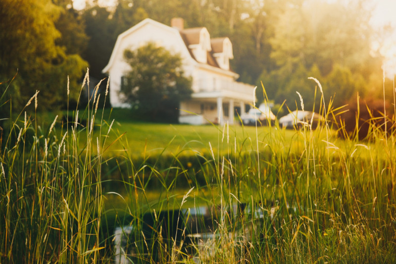 A white house sitting in the middle of a field.