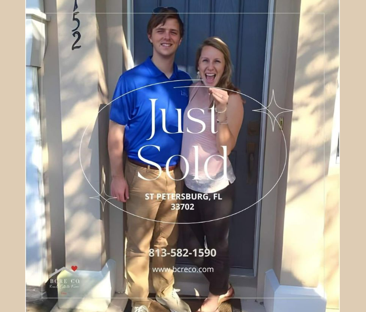 A couple standing in front of their home